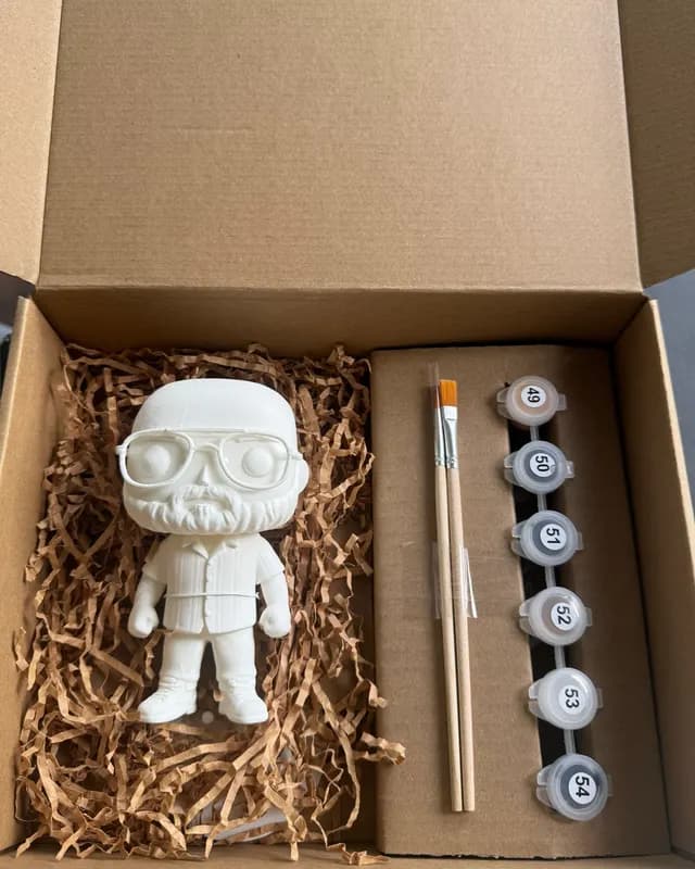 Single unpainted figurine with glasses and beard in its box with brushes